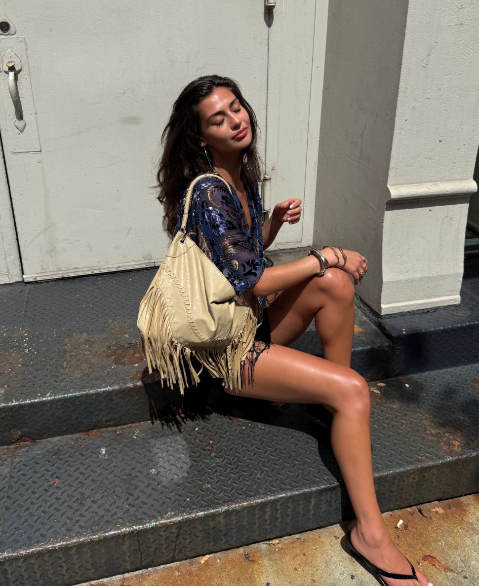 Navy velvet paisley kimono, black shorts, beige fringe bag, and silver bangles.